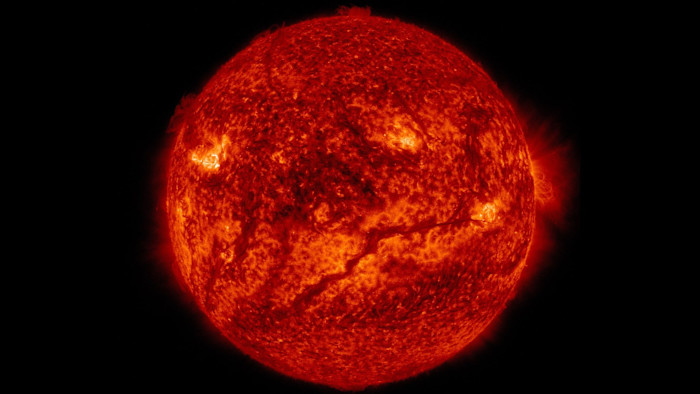NASA SDO 이미지에서 더 차가운 물질로 이루어진 어두운 구불구불한 필라멘트가 태양 표면 아래쪽 절반을 가로지르고 있다.